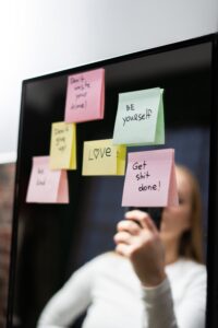 decorative image of mirror with sticky notes that say 'get shit done' and 'be yourself.'